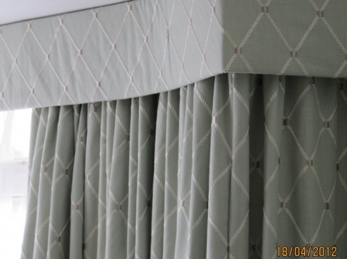 Made to measure flat buckram pelmet In a bay window with matching curtains in Ferring