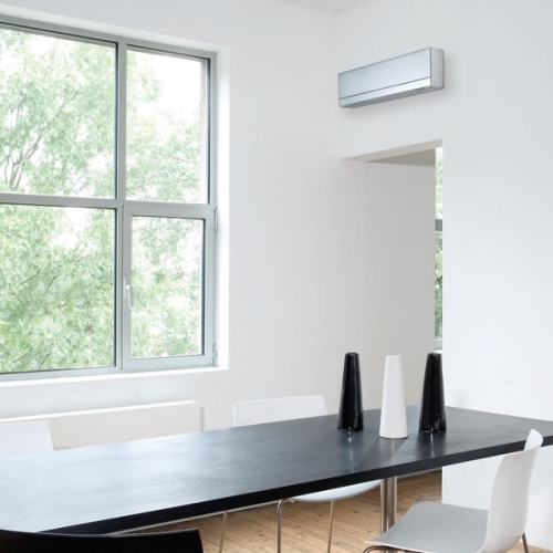 High Level Wall Mounted Air Conditioning Unit In A Residential Dining Room