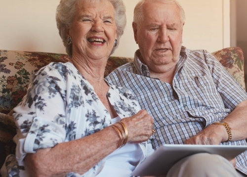 Happy Retired Couple Using Ipad Tablet
