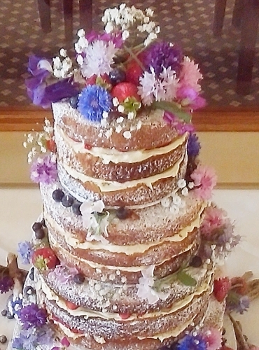 4 Tier Naked Wedding Cake with fresh flowers and Fruits